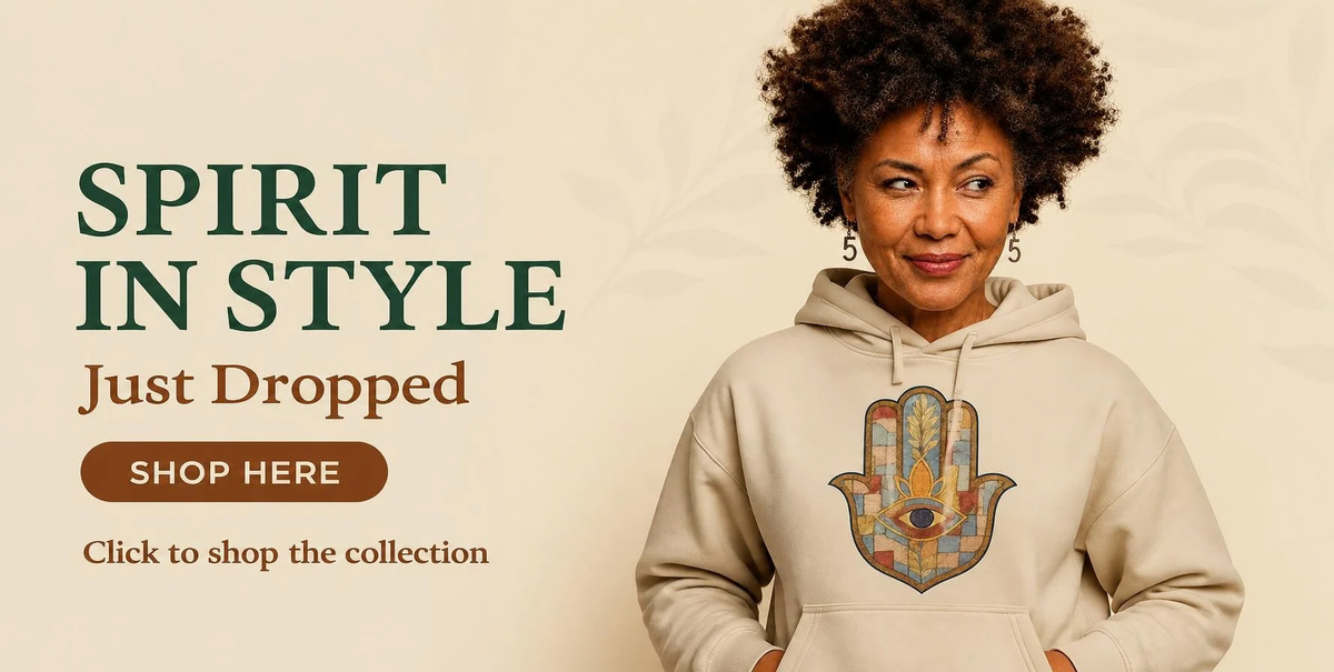 Smiling woman with curly hair wearing a beige Hands On 5th St hoodie with a mosaic Hamsa design, next to the words Spirit In Style, Just Dropped, Shop Here