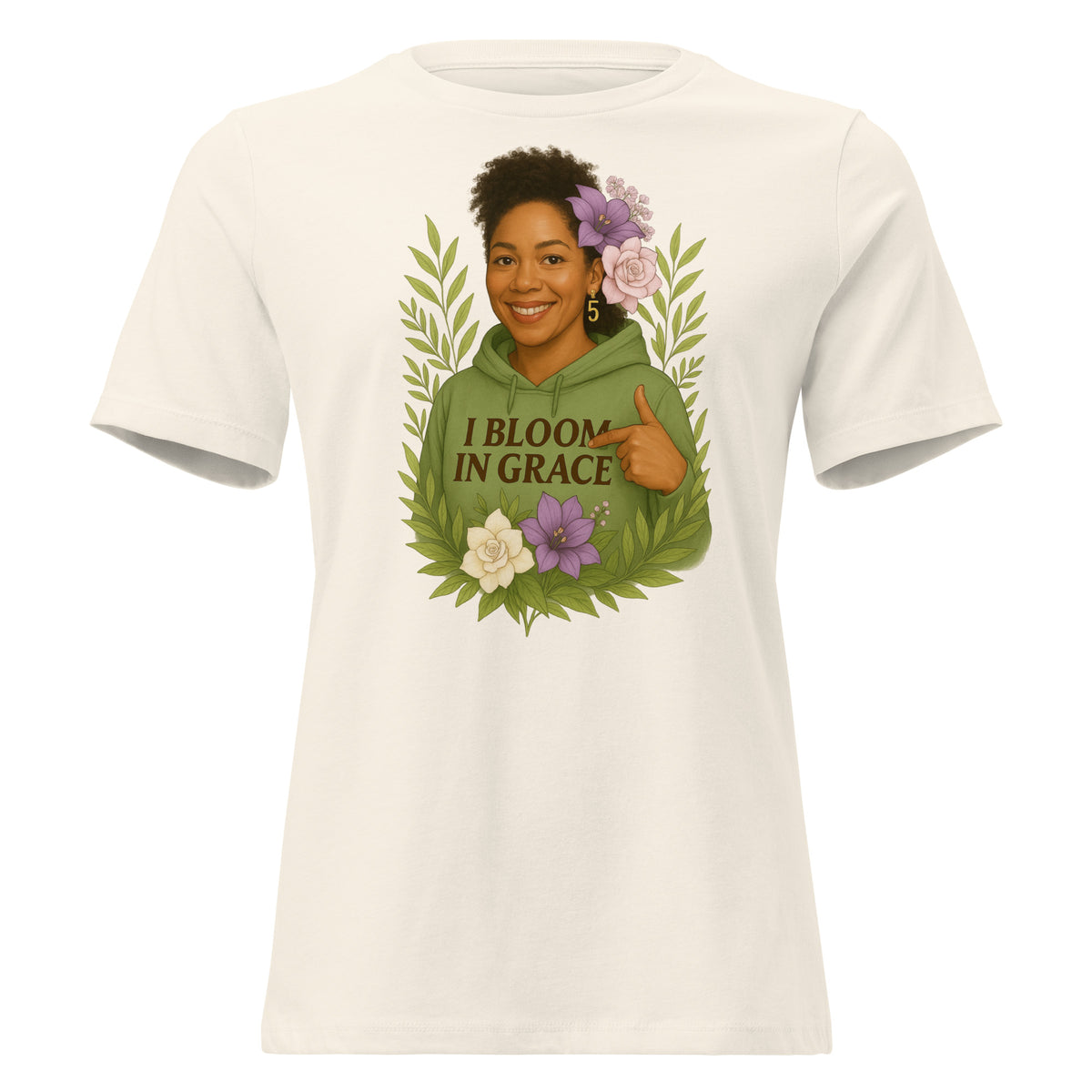 Women's relaxed-fit I Bloom In Grace Exclusive Tee with a smiling woman in a green hoodie framed by flowers and leaves, front view
